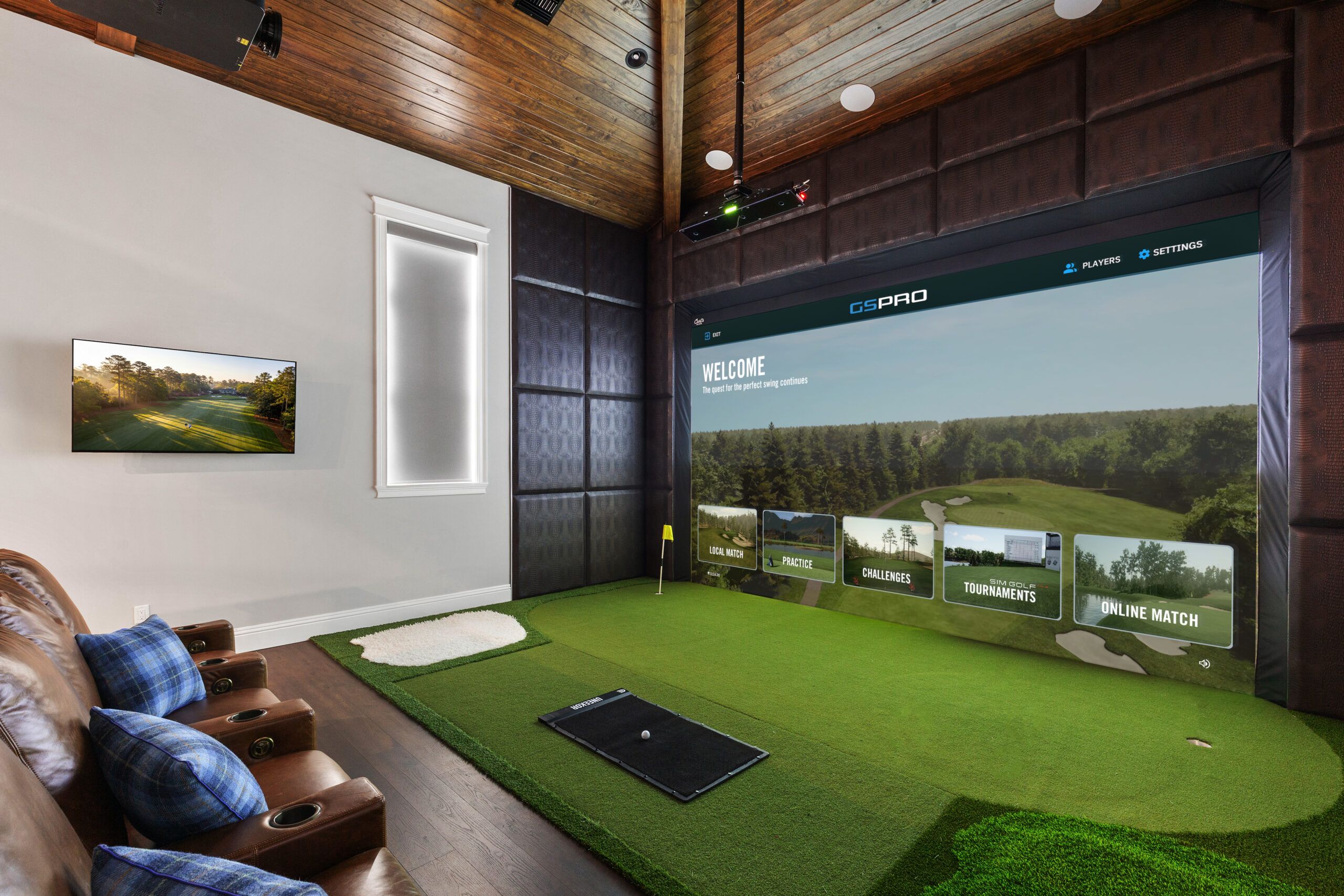 Golf simulator bay beside a living space